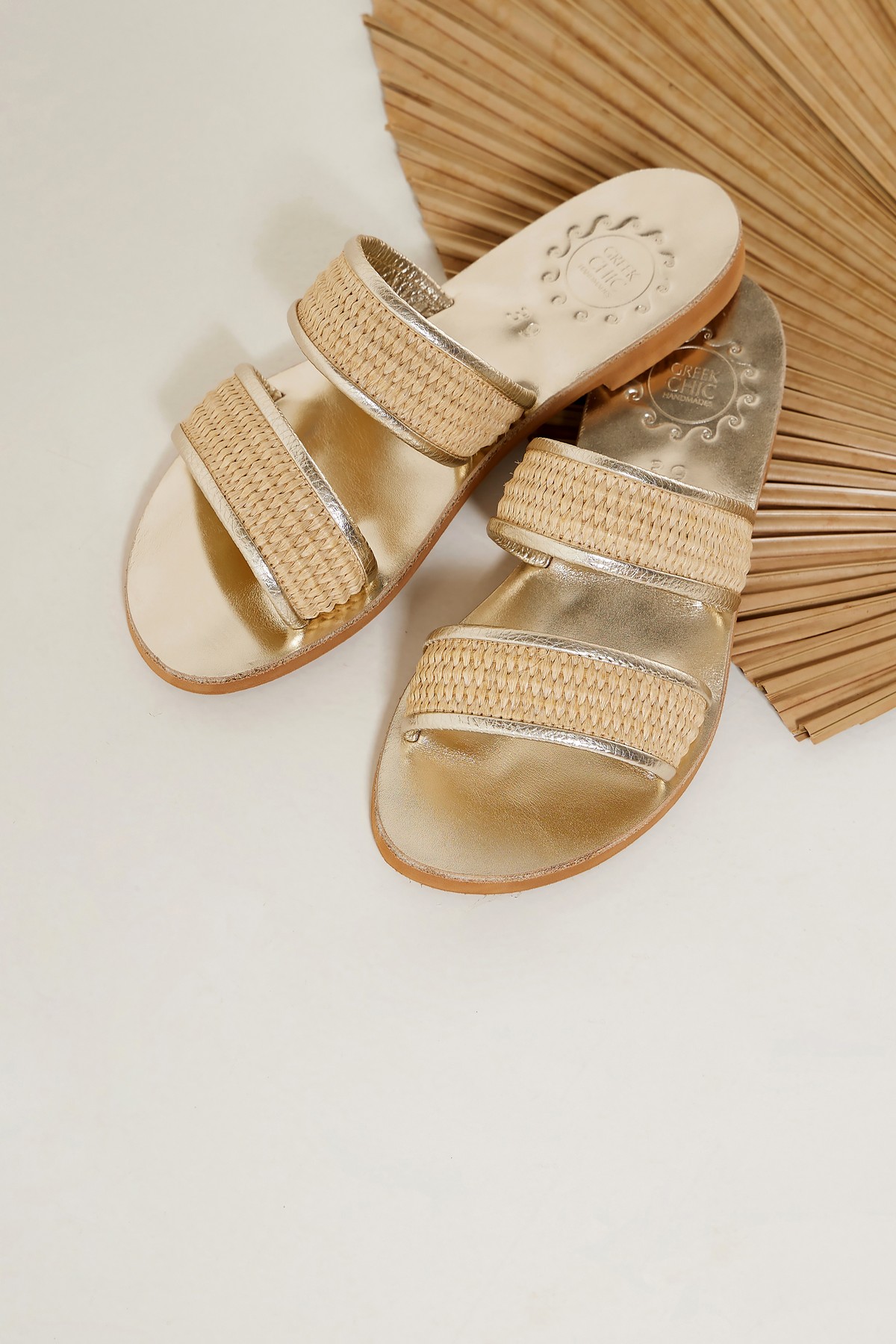 Gold leather sandals with straw
